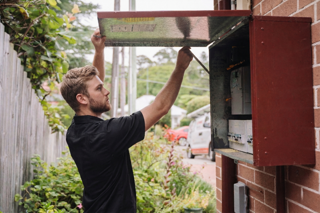 Electrician installing downlights in a Hills Area home